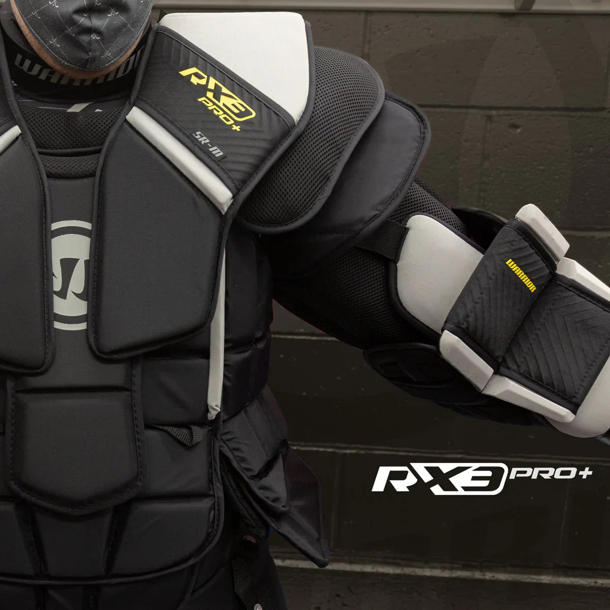 Warrior RX3 Pro+ goalie chest protector close-up, black and white padding, TheHockeyShop.com
